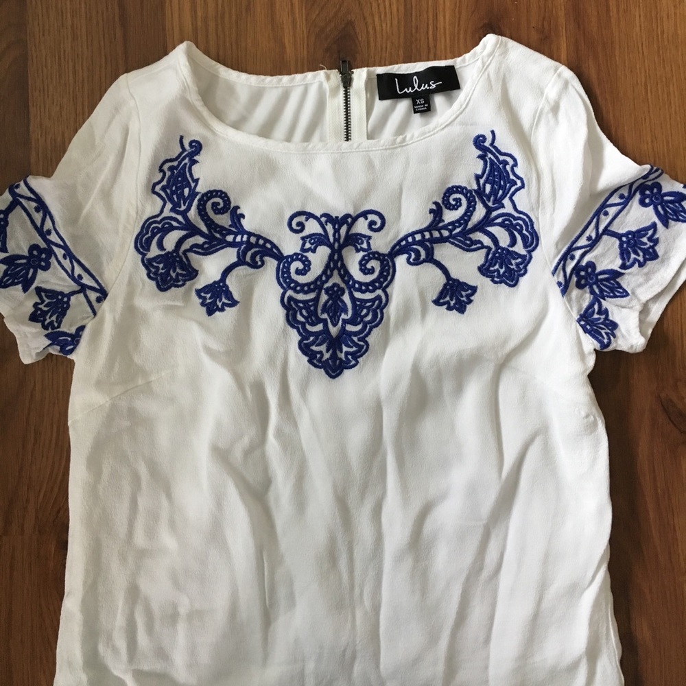 Lulu’s white dress with blue embroidery.